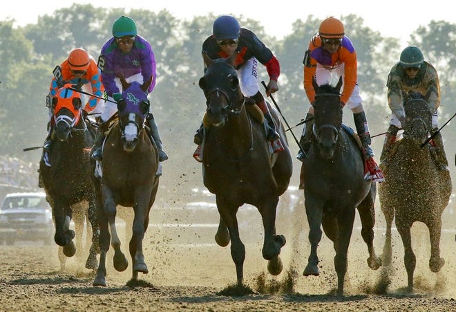 Tonalist, center, with Joel Rosario up, approaches the finish line to win the Belmont Stakes horse race, Saturday, June 7, 2014, in Elmont, N.Y. Other horses are, from left, General a Rod (10), California Chrome (2), Medal Count (1), and Samraat. (AP Photo/Matt Slocum)