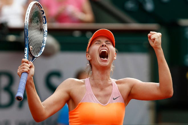 Maria Sharapova celebrates late her in three-set victory over Simona Halep in the championship match at the French Open on Saturday.