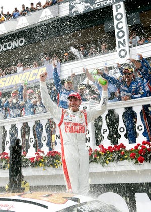 Dale Earnhardt Jr. celebrates Sunday after winning the NASCAR Sprint Cup Series Pocono 400 in Long Pond, Pa. THE ASSOCIATED PRESS