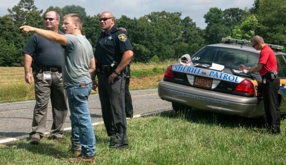 Brandon Sabins, shown speaking with police, helped apprehend a suspect in an attempted robbery at the Padgett BP and Amoco on Monday morning. Sabins and Gary Padgett were able to detain the suspect until Cleveland County sheriff’s deputies arrived.