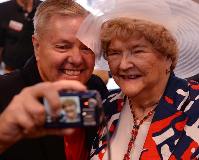 U.S. Senator Lindsey Graham takes a "selfie" with MaryAnn Riley following a campaign stop at the YMCA in Spartanburg, Monday morning, 6-9-2014. Graham made a final stop in Spartanburg before the primary election Tuesday.