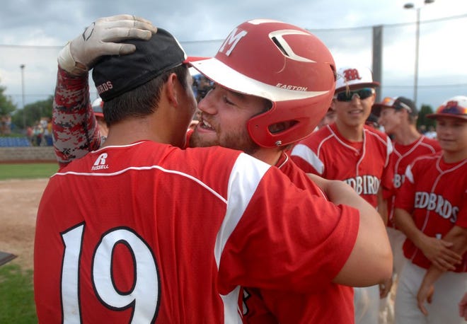 Metamora's Brendan Nachtrieb, facing, hugs pitcher Geremy Guerrero after the Redbirds' 10-0 Class 3A supersectional victory Monday over Sycamore.