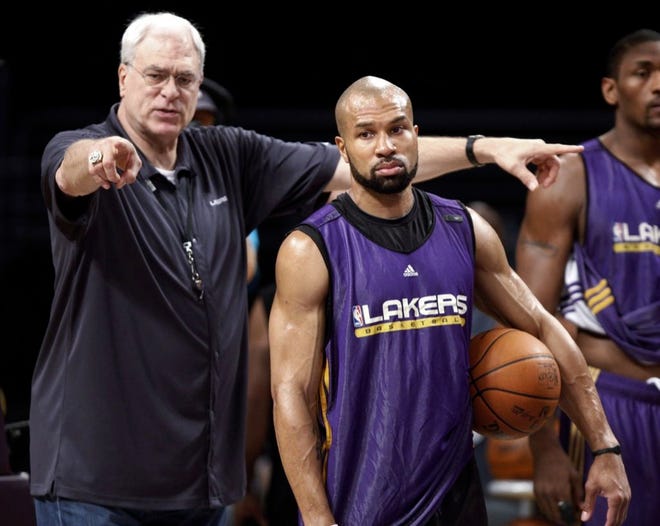 Los Angeles Lakers coach Phil Jackson, left, directs Derek Fisher during practice in 2010. The New York Knicks have scheduled a news conference today amid reports that Fisher has agreed to become the team's basketball head coach.