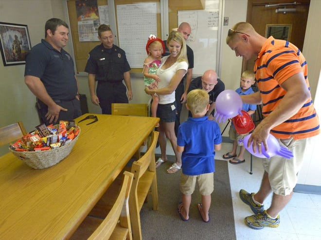 Rachel and Michael Warren and their children, Abigail, 3; Bryson, 7; and Jacob, 6, meet with Polk County Fire Rescue first responders on Friday. The Warrens and Polk County Fire Rescue are partnering to raise drowning-prevention awareness.
