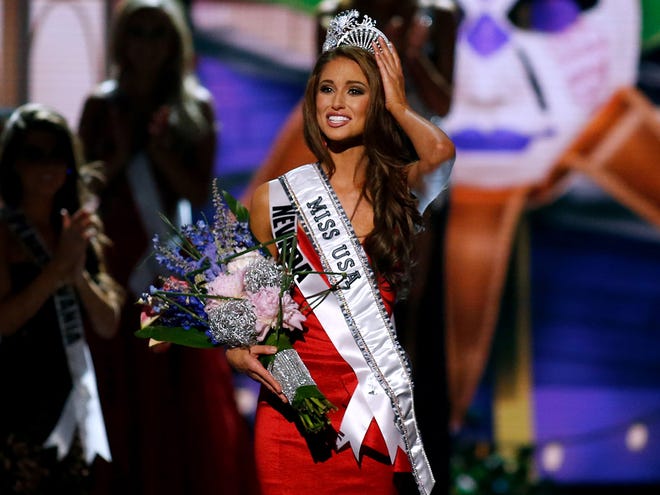 Miss Nevada USA Nia Sanchez adjusts her crown after being crowned the new Miss USA during the Miss USA 2014 pageant in Baton Rouge, La., Sunday.