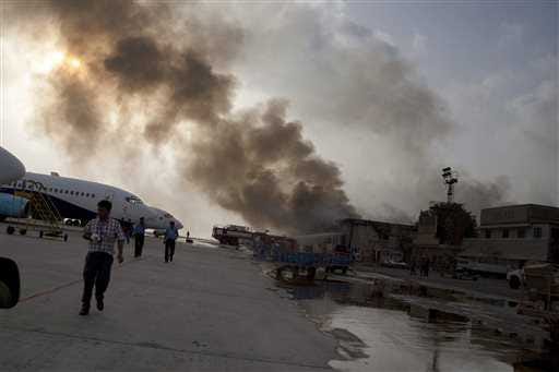 Smoke rises above the Jinnah International Airport as security forces battle militants Monday in Karachi, Pakistan.