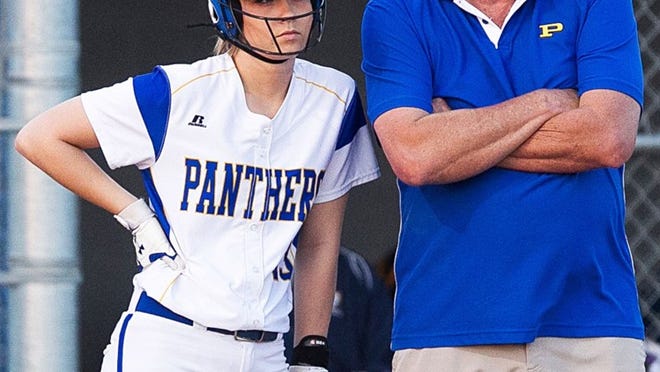 Pflugerville softball coach David Sisson talks with Abby Evans during a Stony Point pitching change this spring at home. (LOURDES M SHOAF for Round Rock Leader.)