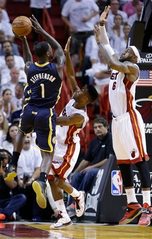 Miami Heat forward LeBron James (6) and Miami Heat guard Norris Cole (30) attempt to block a shot to the basket by Indiana Pacers guard Lance Stephenson (1) during the second half of Game 4 in the NBA basketball Eastern Conference finals playoff series, Monday, May 26, 2014, in Miami. (AP Photo/Wilfredo Lee)