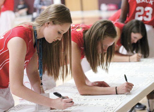 M’Lee Graham from Jim Ned (left) and Eula’s Marleigh Gleason (right), members of the South girls basketball team, were among the Big Country FCA All-Star Festival participants signing memorabilia during the media day event held Tuesday afternoon at Brownwood High’s Warren Gym. The girls and boys basketball doubleheader will start at 6 p.m. Thursday at the Brownwood Coliseum.