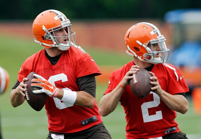 Cleveland Browns quarterbacks Brian Hoyer (6) and Johnny Manziel (2) drop back to pass during a mandatory minicamp practice at the NFL football team's facility in Berea, Ohio Tuesday, June 10, 2014.