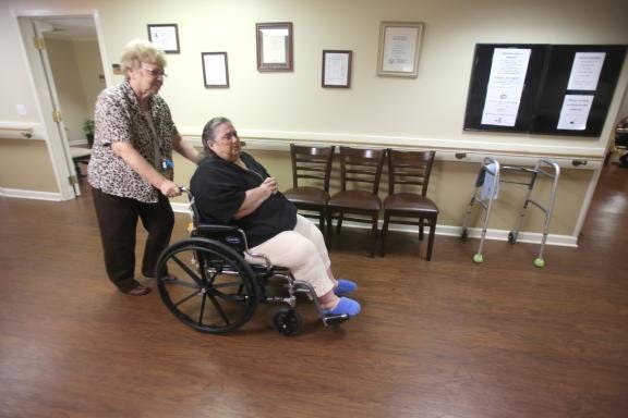 Vergia Strange, the executive director of Cleveland House Assisted Living in Shelby, pushes Ann Sexton, a resident of Cleveland House, around in her wheelchair. Both were upset about the prospect of Medicaid being cut for those who are elderly and living in assisted living centers. Strange said several residents would be forced out onto the street as they have nowhere to go. Sexton is one of those who would be affected.