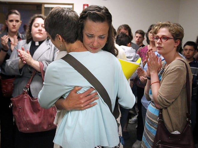 Sam Tasoul, left, and Sara Rabideau embrace after being denied a marriage license by Outagamie County Clerk Lori O'Bright on June 9, 2014 in Appleton, Wis. O'Bright said she was waiting on authorization from the state before issuing licenses. The decision was later reversed and applications for marriage licenses were accepted, subject to a five day waiting period. (AP Photo/The Post-Crescent, Wm.Glasheen) NO SALES Wm.Glasheen/Post-Crescent Media