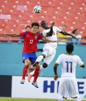 South Korea's Chu Young Park, left, and Ghana' Jonathan Mensah battle for the ball Monday during the first half of an exhibition match in Miami Gardens. Ghana will be Team USA's first opponent Monday.