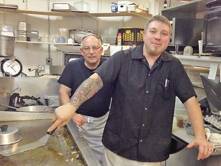 Frank Killerby, left, and his son, Jason, in the kitchen of the Trackside Cafe in Exeter Monday afternoon. The diner reopened last week.