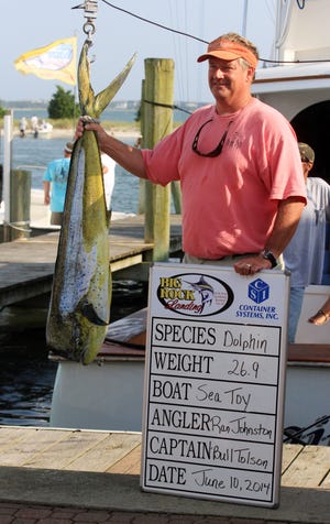 Angler Ron Johnston poses with a 26.9-pound bull dolphin fish that he caught aboard the vessel Sea Toy, skippered by Bull Tolson on Tuesday in the Big Rock Blue Marlin Tournament at Morehead City.