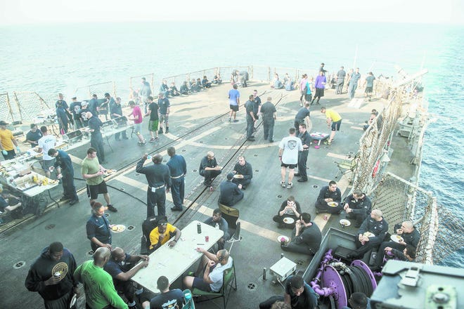 Sailors participate in a steel beach picnic aboard the guided-missile cruiser USS Philippine Sea (CG 58). Philippine Sea is deployed as part of the George H.W. Bush Carrier Strike Group.