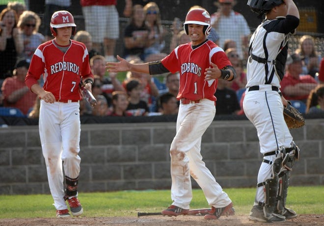FILE PHOTO -- Metamora's Ethan Skender (1) celebrates his score against Sycamore as teammate Caleb Brachbill gets ready to bat during their Class 3A state supersectional in Rock Island on June 9, 2014.