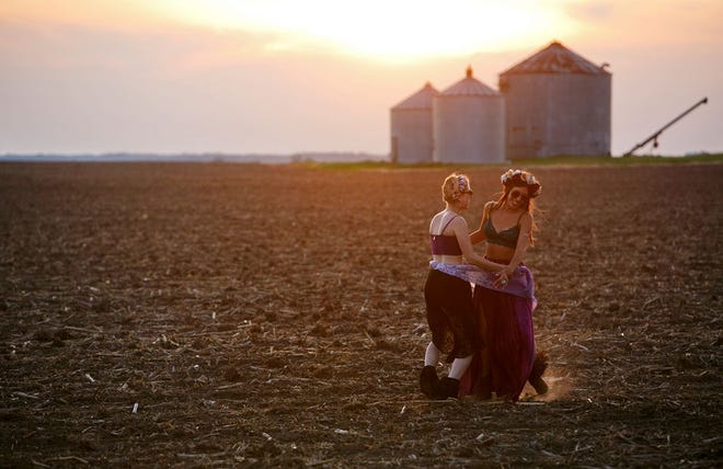 Sarah Theresa, left, of Ashville, N.C. and Blair Garnett of Portland, Ore. dance in a field at sunset nea the Sunshine Stage on Sunday, May 25 at the Summer Camp Music Festival in Chilicothe.