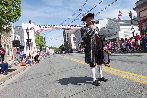 Photo by Daniel Freel/New Jersey Herald - William Joseph, Newton town crier, stands in front of a re-created archway as he welcomes gatherers to the Newton Memorial Day Parade May 26. Joseph will formally announce Newton Day ceremonies at 11 a.m. June 14.