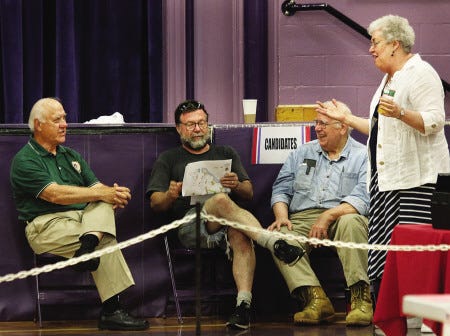Selectman candidates Roland Fernald, left, and Jack Murphy and state Rep. Bobbi Beavers talk with an Eliot resident who wished to remain unidentified at the polls at Marshwood Middle School on Tuesday.