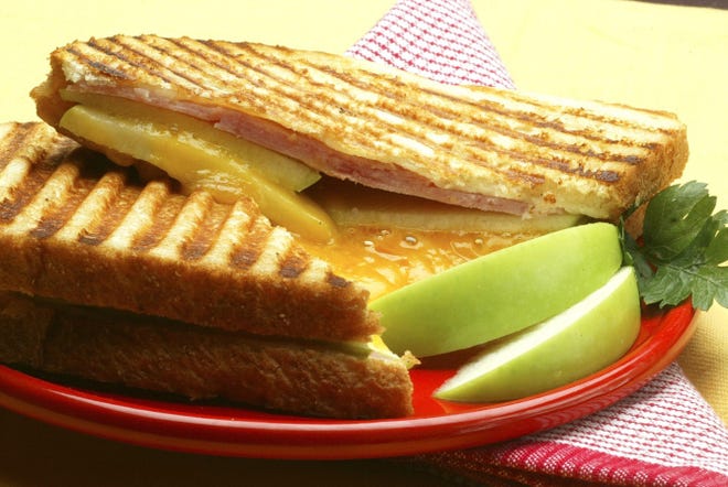 Grilled cheese sandwich with apple, ham and Cheddar cheese on sourdough bread.