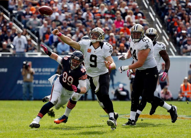 New Orleans Saints quarterback Drew Brees (9) throws a pass as Chicago Bears defensive end Shea McClellin (99) pressures him on Oct. 6, 2013, in Chicago. McClellin has made the switch to linebacker this year.