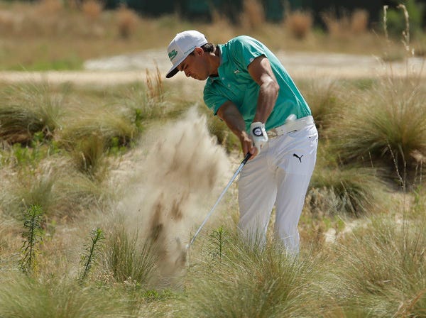Rickie Fowler hits out of the long grass on the 18th hole during a practice round for the U.S. Open in Pinehurst, N.C., on Wednesday. (Charlie Riedel | Associated Press)