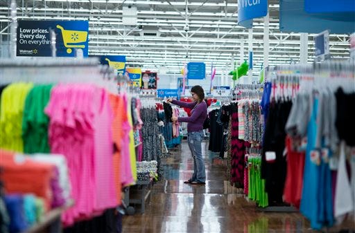 In this June 5, 2014 photo, Chelsea Vick shops for clothes at Wal-Mart Supercenter in Rogers, Ark. The Commerce Department releases retail sales data for May on Thursday, June 12, 2014. (AP Photo/Sarah Bentham)
