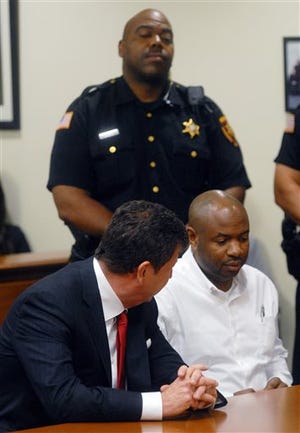 Kevin Roper, right, listens to his attorney David Glassman during Roper's arraignment at the Middlesex County Courthouse Wednesday, June 11, 2014, in New Brunswick, N.J. Roper, a Wal-Mart truck driver from Georgia, pleaded not guilty to death by auto and assault by auto charges, in the wake of a deadly chain-reaction crash on the New Jersey Turnpike early Saturday, June 7, 2014, that killed comedian James McNair and left actor-comedian Tracy Morgan and two others critically injured. (AP Photo/Princeton Packet, Phil McAuliffe, Pool