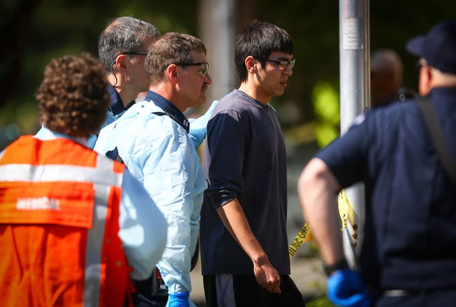 Jon Meis is taken from the scene by medics after he pepper sprayed and tackled a shooting suspect at Seattle Pacific University, in Seattle, Thursday, June 5, 2014. At a time when shootings seem to happen almost daily, how should Americans react if someone opens fire at work, at school or at a theater or store? The Associated Press consulted experts on what to do.