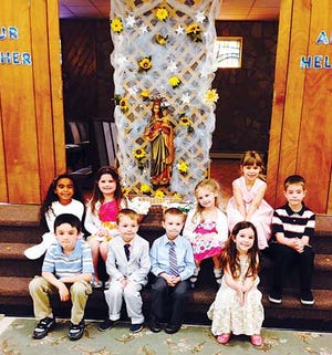 Submitted photo - The Auxilium School kindergarten class is pictured here in front of the Blessed Mother at the school’s May Crowning.