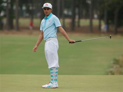 Rickie Fowler reacts to his missed birdie putt on the 14th hole during the first round of the U.S. Open golf tournament in Pinehurst, N.C., Thursday, June 12, 2014. (AP Photo/Charlie Riedel)