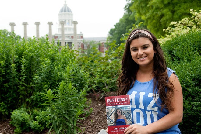 Jamie Goodman poses with her book, “Jamie’s Journey: Travels with my Dad,” June 6 on the MU campus.