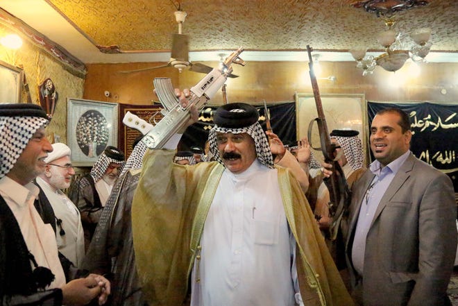 Iraqi Shiite tribal leaders chant slogans against the al-Qaida-inspired Islamic State of Iraq and the Levant (ISIL), in Baghdad, Iraq, Friday, June. 13, 2014. The tribal leaders met in Sadr city on Friday and declared their readiness along with their tribesmen to take up arms against the al-Qaida inspired group that had in Iraqís made advance Sunni heartland.