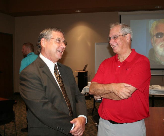 Ionia County Intermediate School District Deputy Superintendent Mike Keast chats with Kevin Meade during his retirement party Thursday afternoon.