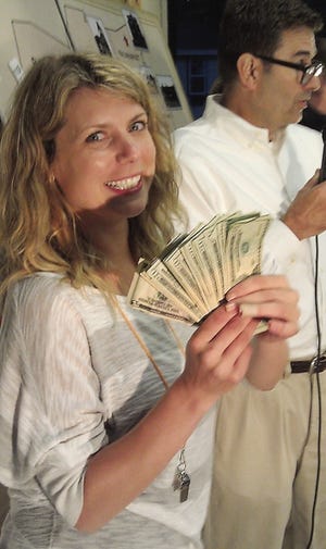 Krysta Seckendorf, marketing and events director for the Exeter Area Chamber, gives away money at the 2013 Chamber Sweepstakes.