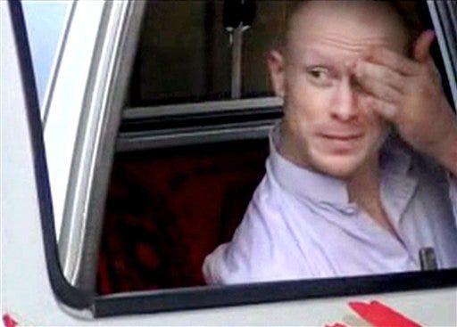In this image taken from video obtained from Voice Of Jihad Website, which has been authenticated based on its contents and other AP reporting, Sgt. Bowe Bergdahl, sits in a vehicle guarded by the Taliban in eastern Afghanistan.
