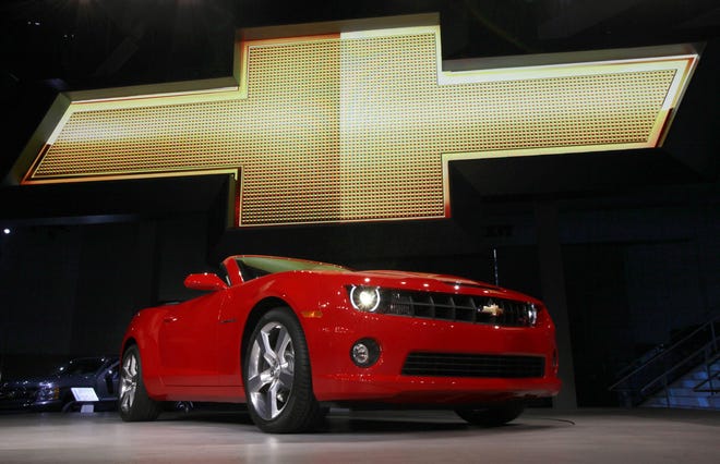 In this Wednesday, Nov. 17, 2010, file photo, the 2011 Chevrolet Camaro convertible debuts at the Los Angeles Auto Show. General Motors is recalling nearly 512,000 Chevrolet Camaro muscle cars from the 2010 to 2014 model years. A driver's knee can bump the key and knock the switch out of the "run" position, causing an engine stall. THE ASSOCIATED PRESS