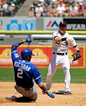 Chicago White Sox second baseman Gordon Beckham, right, throws out Kansas City Royals' Nori Aoki, of Japan, at first base after forcing out Alcides Escobar (2) at second base during the fourth inning of a baseball game in Chicago on Saturday, June 14, 2014. (AP Photo/Nam Y. Huh)