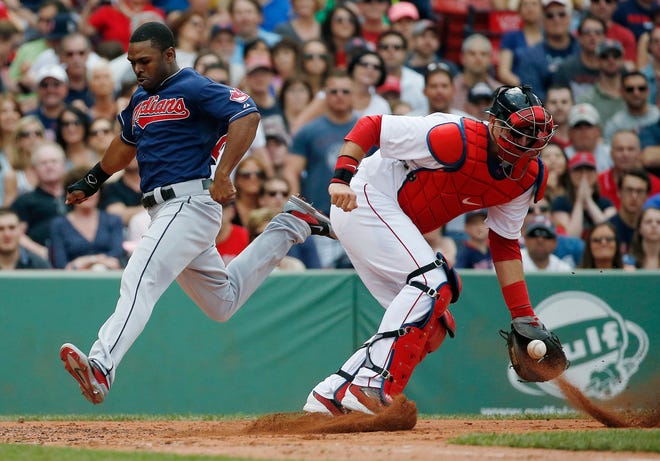 Michael Bourn scores as he runs around A.J. Pierzynski during the Indians' win at Fenway Park. AP PHOTO/MICHAEL DWYER