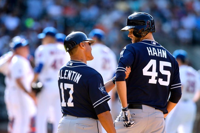 San Diego first base coach Jose Valentin, left, congratulates pitcher Jesse Hahn after Hahn hit an RBI single during the fourth inning against the Mets in New York. Hahn earned his first Major League victory in a 5-0 win. AP Photo/Jason DeCrow