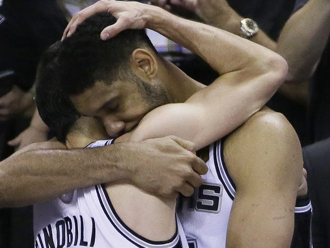 Spurs guard Manu Ginobili, left, and forward Tim Duncan embrace in the final moments of Game 5 on Sunday night in San Antonio.