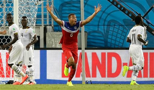 United States' John Brooks, centre, celebrates after scoring his side's second goal during the group G World Cup soccer match between Ghana and the United States at the Arena das Dunas in Natal, Brazil, Monday, June 16, 2014. The United States won the match 2-1. (AP Photo/Ricardo Mazalan)
