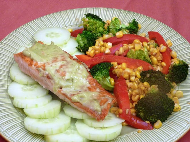 Wasabi adds a dash of spice to pan-roasted salmon as the wasabi-coated fish is served atop a bed of sliced cucumbers with a saute of broccoli, corn and red peppers.
