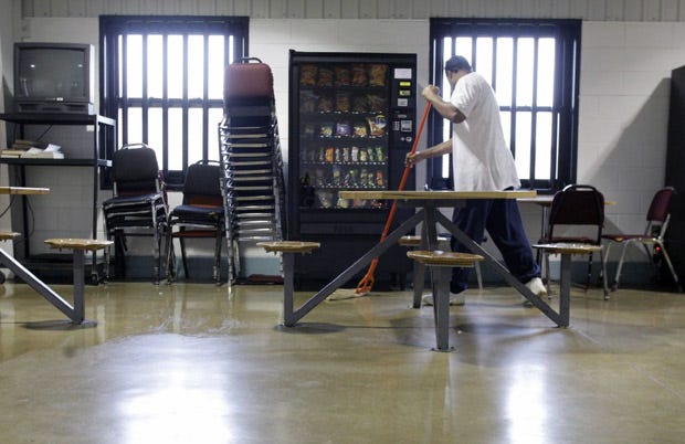 An inmate mops the floor in the merit dorm at North Central Correctional Institution in Marion.