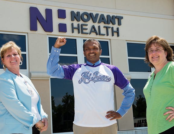 Bob Koneru, a pharmacist at Novant Health Thomasville Medical Center who is a diabetic, will throw out the ceremonial first pitch before the HiToms baseball game against Team USA on June 23. Koneru, sporting the official TMC staff HiToms shirt, is flanked by TMC Foundation director Susan Reece (left) and TMC Disease and Wellness navigator Marcy Shipwash. TMC will be offering a diabetes screening for fans in attendance before the game.