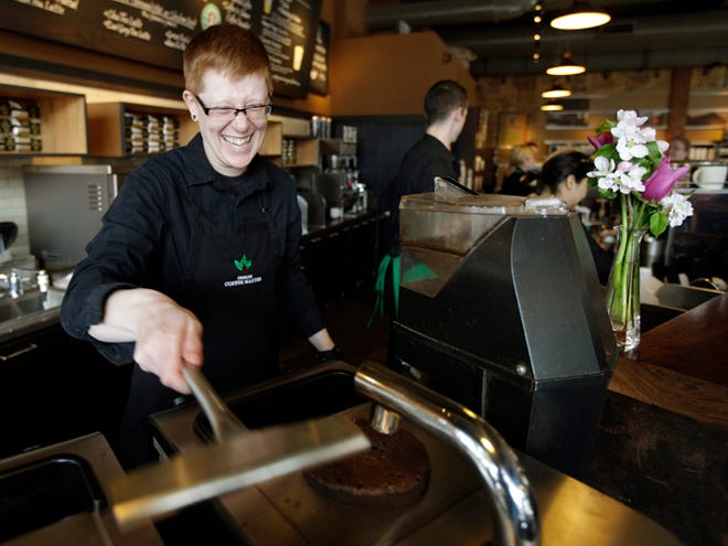 Starbucks barista Linsey Pringle prepares a cup of coffee on April 27, 2012, at a Starbucks Corp. store in Seattle. Starbucks on Monday announced a new partnership with Arizona State University to make online degrees available to its 135,000 U.S. employees who work at least 20 hours a week.