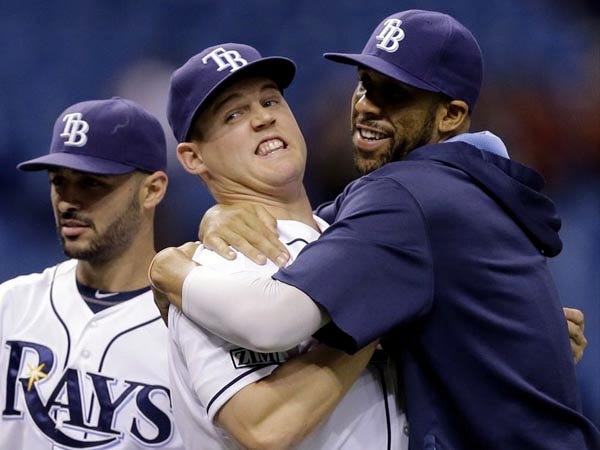 Tampa Bay's Jerry Sands, center, celebrates with David Price, right, and Sean Rodriguez on Monday after the Rays' 5-4 victory over the Baltimore Orioles in St. Petersburg. Sands hit an eighth inning, two-run home run.
