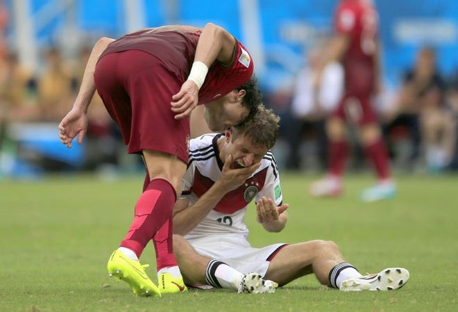 Portugal's Pepe slightly head-butts Germany's Thomas Mueller on Monday during Germany's 4-0 win in Salvador, Brazil. Pepe was red carded and Mueller went on to score three goals.