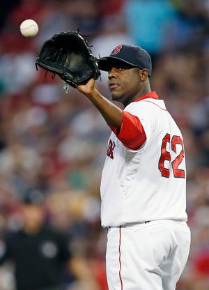 Boston Red Sox starter Rubby De La Rosa gets the ball back during the fifth inning of a baseball game against the Minnesota Twins in Boston, Monday, June 16, 2014.